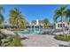 Gorgeous community pool with ample seating, shade, and a picturesque clubhouse at 13549 Old Creek Ct, Parrish, FL 34219