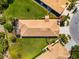 Aerial view of the house displaying the roof, screened-in patio, and surrounding landscaping at 138 Tiziano Way, North Venice, FL 34275