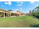 Expansive backyard with large lawn, outdoor seating area, and covered patio; perfect for entertaining guests at 138 Tiziano Way, North Venice, FL 34275