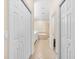 Hallway view of a bright bathroom with double sinks, a soaking tub, and a glass-enclosed shower at 138 Tiziano Way, North Venice, FL 34275