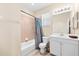 Functional bathroom featuring a shower-tub combo with tile surround, complemented by a vanity with storage at 138 Tiziano Way, North Venice, FL 34275