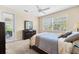 Comfortable bedroom featuring a door to the patio and a large window, creating a serene and bright space at 138 Tiziano Way, North Venice, FL 34275