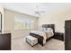 Cozy bedroom with a large window for natural light, complemented by a ceiling fan and neutral color palette at 138 Tiziano Way, North Venice, FL 34275