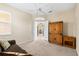 Comfortable bedroom with brown loveseat, storage cabinet, and open doorway for a spacious feel at 138 Tiziano Way, North Venice, FL 34275