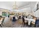 Elegant dining area featuring chandeliers, neutral colors, and ample seating for residents and guests alike at 138 Tiziano Way, North Venice, FL 34275