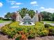 Community entrance sign with decorative lions, lush landscaping, and a water feature at 138 Tiziano Way, North Venice, FL 34275