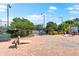 Outdoor brick patio featuring games and seating amongst tropical plants and lush landscaping at 138 Tiziano Way, North Venice, FL 34275