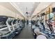 Well-equipped fitness center with state-of-the-art treadmills, elliptical machines, and floor to ceiling windows at 138 Tiziano Way, North Venice, FL 34275