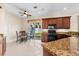 Well-lit kitchen features granite countertops, modern appliances, and a breakfast nook with backyard access at 138 Tiziano Way, North Venice, FL 34275