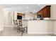 Kitchen island with bar stool seating and pendant lighting at 138 Tiziano Way, North Venice, FL 34275