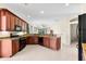 Bright kitchen featuring dark cabinets, granite countertops, and modern appliances at 138 Tiziano Way, North Venice, FL 34275