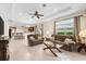 Spacious open-concept layout with tile floors, living room, kitchen, and bar stool seating at 138 Tiziano Way, North Venice, FL 34275