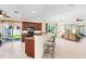 Open living area with tile floors, kitchen bar, and sliding glass doors to the backyard at 138 Tiziano Way, North Venice, FL 34275