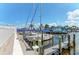 Marina view featuring docked sailboats with blue sails, reflecting the clear blue sky and waterfront structure at 138 Tiziano Way, North Venice, FL 34275