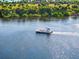Scenic water scene featuring a boat on the water, surrounded by nature at 138 Tiziano Way, North Venice, FL 34275