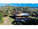 Unique aerial view of a custom-built home surrounded by lush trees and landscaping at 1409 57Th W St # 1409, Bradenton, FL 34209