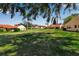 Community backyard with well manicured lawn and landscaping around the perimeter of the buildings at 1409 57Th W St # 1409, Bradenton, FL 34209