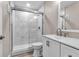 Modern bathroom featuring glass-enclosed shower, white vanity, contemporary fixtures, and neutral color palette at 1409 57Th W St # 1409, Bradenton, FL 34209