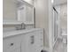 Bathroom featuring a modern vanity with light countertop, framed mirror, and glass-enclosed shower at 1409 57Th W St # 1409, Bradenton, FL 34209