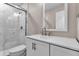 Bathroom with marble-look shower, brushed metal fixtures and white vanity at 1409 57Th W St # 1409, Bradenton, FL 34209