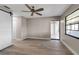 A spacious bedroom is brightly lit, featuring wood flooring, a ceiling fan, and a barn door entrance to the closet at 1409 57Th W St # 1409, Bradenton, FL 34209