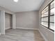 Bedroom with wood-look flooring, closet and window at 1409 57Th W St # 1409, Bradenton, FL 34209