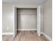 Empty closet with open doors showcasing wood-look floors, neutral paint, and built-in shelving at 1409 57Th W St # 1409, Bradenton, FL 34209