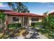 Charming single-story villa with a red tile roof, neat landscaping, and inviting walkway, creating great curb appeal at 1409 57Th W St # 1409, Bradenton, FL 34209