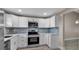 Clean kitchen featuring white cabinets, stainless steel appliances, and modern backsplash at 1409 57Th W St # 1409, Bradenton, FL 34209