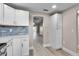 Bright kitchen with white cabinets, granite counters, stainless steel appliances, and views of the main living area at 1409 57Th W St # 1409, Bradenton, FL 34209