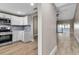 Stylish kitchen with modern white cabinets, stainless steel appliances, and a view of the adjacent living space at 1409 57Th W St # 1409, Bradenton, FL 34209