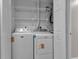 Laundry closet featuring a white washer and dryer, shelves, and modern fixtures at 1409 57Th W St # 1409, Bradenton, FL 34209