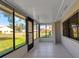 Bright sunroom featuring tile flooring, large windows providing abundant natural light and serene outdoor views at 1409 57Th W St # 1409, Bradenton, FL 34209