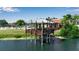 Lake view featuring a wooden pavilion on stilts overhanging the water with nearby pool at 1409 57Th W St # 1409, Bradenton, FL 34209