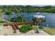 Scenic aerial view of a community pavilion overlooking a serene lake with lush landscaping at 1409 57Th W St # 1409, Bradenton, FL 34209