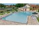 Large community pool surrounded by lounge chairs and tables for residents to enjoy at 1409 57Th W St # 1409, Bradenton, FL 34209
