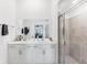 This bathroom features double sinks, a large mirror, white cabinets, and a glass shower at 14257 Heritage Landing Blvd # 1122, Punta Gorda, FL 33955