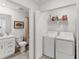 View of a bathroom with single sink, shower-tub, and a laundry area with full size washer and dryer at 14257 Heritage Landing Blvd # 1122, Punta Gorda, FL 33955