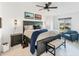 This is a primary bedroom with a king bed, ceiling fan, accent chair, and waterfront themed artwork at 14257 Heritage Landing Blvd # 1122, Punta Gorda, FL 33955