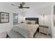 This bedroom features a gray upholstered headboard, ceiling fan, lamps, and bench at 14257 Heritage Landing Blvd # 1122, Punta Gorda, FL 33955