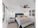 This bedroom has a gray upholstered headboard, ceiling fan, and two nightstands with lamps at 14257 Heritage Landing Blvd # 1122, Punta Gorda, FL 33955