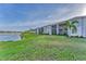 Exterior view of the townhome complex showing the lake and units with patios or decks at 14257 Heritage Landing Blvd # 1122, Punta Gorda, FL 33955