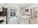 Modern kitchen features white cabinets, an island with seating, and access to the lanai at 14257 Heritage Landing Blvd # 1122, Punta Gorda, FL 33955