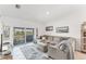 Open living room with comfortable sofa and access to balcony overlooking scenic views at 14257 Heritage Landing Blvd # 1122, Punta Gorda, FL 33955