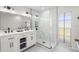 Bright bathroom featuring double sinks, sleek fixtures, and modern shower at 1527 Buoy Ln, Osprey, FL 34229