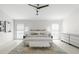 Modern bedroom with decorative ceiling fan, neutral decor, and tile flooring at 1527 Buoy Ln, Osprey, FL 34229