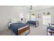Well-lit bedroom with two twin beds, modern decor, and ample natural light at 1527 Buoy Ln, Osprey, FL 34229