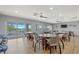 Club room with neutral tones, multiple tables, and view to outdoor amenities at 1527 Buoy Ln, Osprey, FL 34229