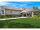 Exterior of clubhouse with covered entry, manicured lawn, and professional landscaping at 1527 Buoy Ln, Osprey, FL 34229