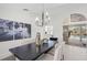 Bright dining room with stylish chandelier, seating, and view to the pool at 1527 Buoy Ln, Osprey, FL 34229